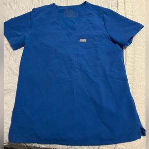Women’s royal blue Catarina- one pocket scrub top. Color royal blue